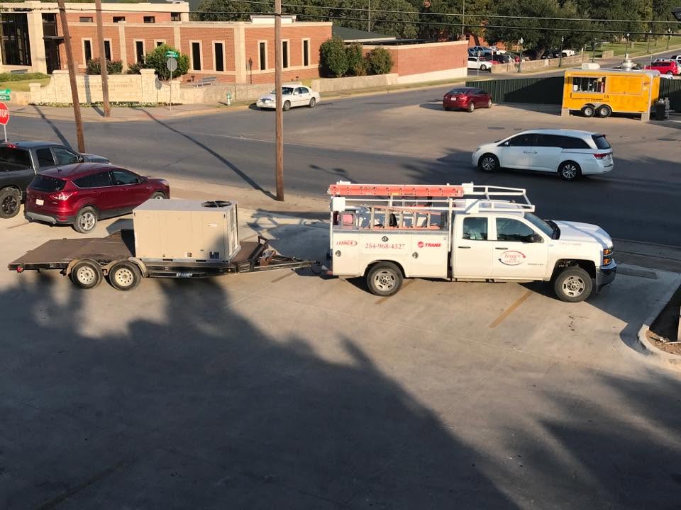 Jessie's Air Service truck and trailer loaded with HVAC equipment in Stephenville TX